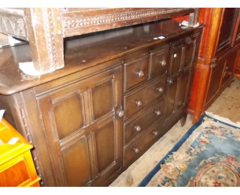 Ercol dark ash sideboard and a set of four chairs