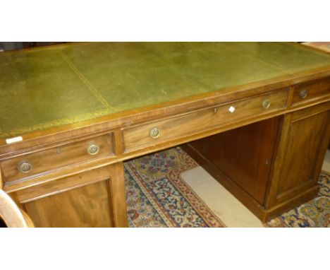 19th Century mahogany partners desk, the leather inset top above drawers and cupboard doors enclosing further drawers raised 