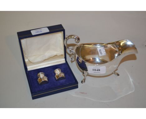 Birmingham silver helmet shaped cream jug on low hoof supports and a pair of small silver peppers in box