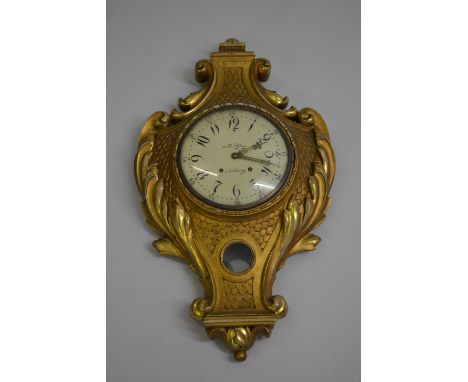 Large 19th Century continental carved and gilded cartel type wall clock, the acanthus and scale decorated case with pendulum 