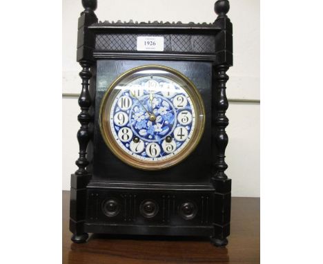 Ebonised cased mantel clock having circular blue and white ceramic dial with Arabic numerals and two train eight day movement
