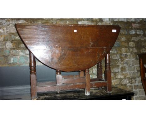Small early 18th Century oak gate leg table, the oval top on turned supports with plain stretchers, 42ins wide