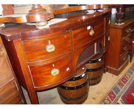 Georgian mahogany bow fronted sideboard, the plain top above an arrangement of four drawers with tambour front centre on squa