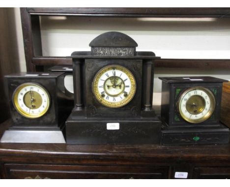 19th Century black slate mantel clock having circular brass dial with white chapter ring and Roman numerals, visible escapeme