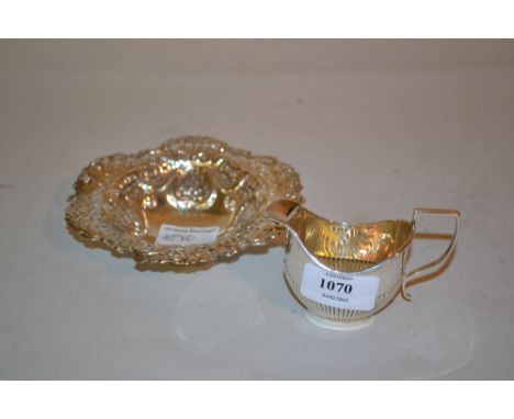Birmingham silver miniature cream jug and an embossed and pierced silver trinket dish