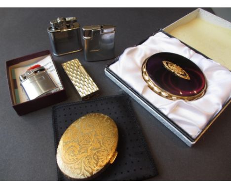 Kigu compact in original box, various other compacts, perfume atomiser and four cigarette lighters