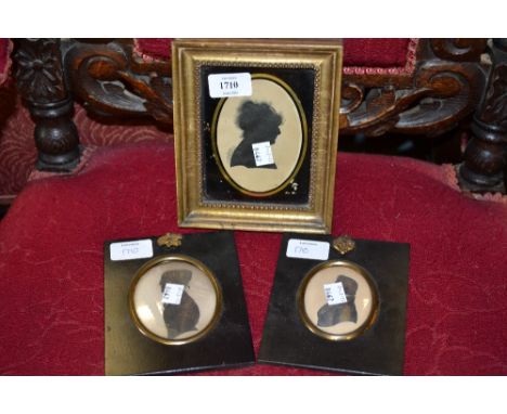 Early 19th Century silhouette portrait of a lady, gilt framed, together with two other silhouette portraits, heightened in gi