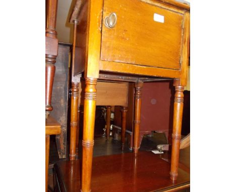 George III mahogany pot cupboard having galleried top over single door raised on ring turned tapering supports