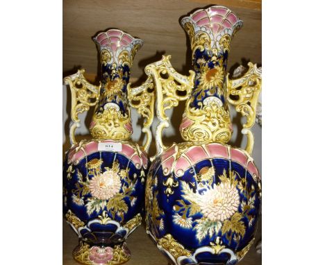 Pair of large Hungarian Zsolnay two handled pottery vases with floral relief moulded decoration