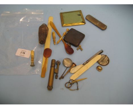 Brass Trench Art lighter made from a bullet case, blued steel vesta case, letter seal, two bone spoons and a small quantity o