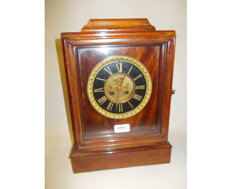 Walnut cased two train mantel clock, the black dial with Roman numerals and two train movement with visible escapement