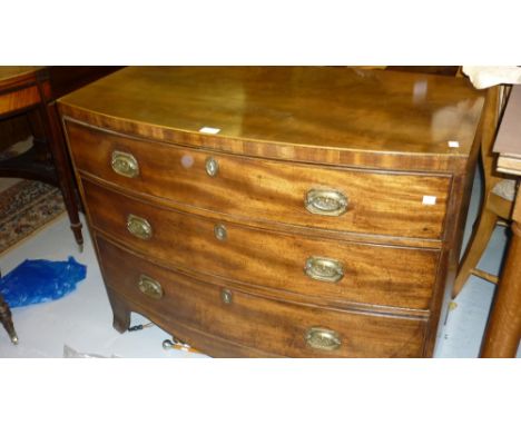 George III mahogany and boxwood inlaid bow fronted chest of three long drawers with brass handles raised on bracket supports