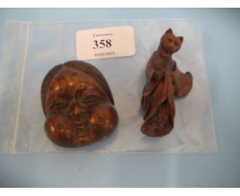 Miniature Japanese carved wooden mask, signed, together with a netsuke in the form of a cat dressed as a geisha CONDITION REP