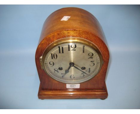 Early 20th Century mahogany dome shaped mantel clock, the silvered dial with Arabic numerals and two train movement