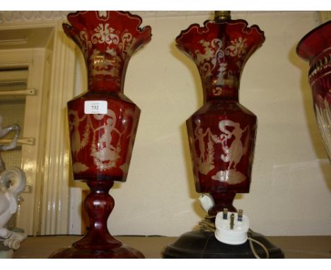 19th Century Bohemian red flash faceted baluster form vase on circular foot with all-over etched decoration of figures etc to