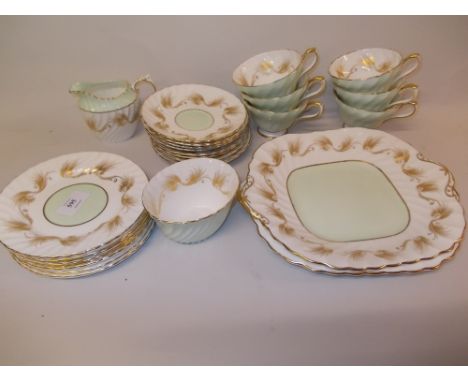 Aynsley gilt decorated tea and cake set on a pale green and white ground comprising: six cups and saucers, cream jug, sugar b