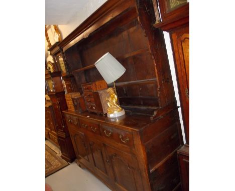 Mid 18th Century oak dresser, the boarded shelf back above three drawers and two fielded panel doors flanking a central fixed