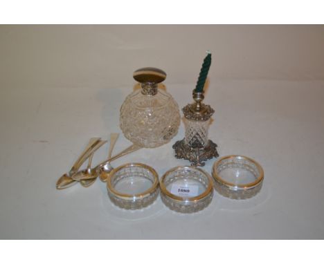 Three silver mounted cut glass butter dishes and a metal mounted cut glass taper stick together with five silver teaspoons an