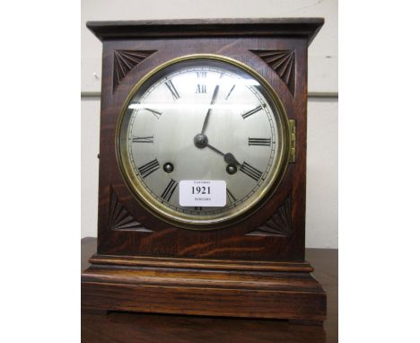 20th Century oak cased mantel clock having circular silvered dial with Roman numerals and eight day two train movement striki