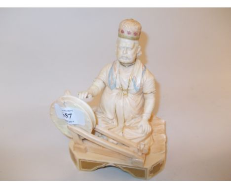 Royal Worcester blush ivory figure of a seated oriental (slight damage)