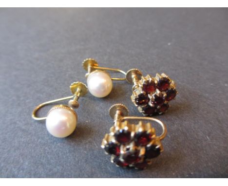 Pair of pearl, 9ct gold mounted screw back earrings together with another pair set with garnet clusters