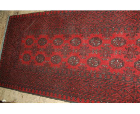 Modern red ground Afghan runner, 2.86m x 0.78m
N.B. This carpet is subject to vat on the hammer price.
