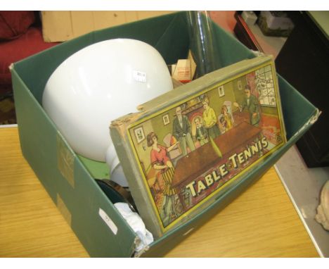 Brass oil lamp with opaque glass shade, various board games, books and a table tennis set