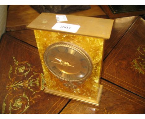 1970's Asprey gilt metal mounted and resin mantel clock, the circular dial with Roman numerals, 6.5ins high, 5ins wide