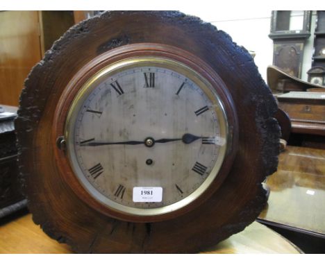 Unusual mantel clock with natural cut and polished tree trunk case and circular silvered dial with Roman numerals and single 