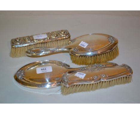 Sheffield silver floral embossed Art Nouveau style three piece dressing table set and another silver backed floral embossed b