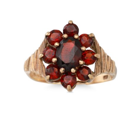 A VINTAGE GARNET DRESS RING, mounted in 9ct yellow gold, size L - M