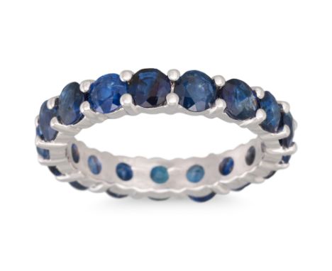 A SAPPHIRE ETERNITY RING, circular stones mounted in 18ct white gold. Estimated: weight of sapphires: 3.66 ct. size L - M