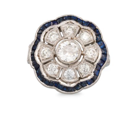 A VINTAGE DIAMOND AND SAPPHIRE DAISY CLUSTER RING, the central old cut diamond to a diamond &amp; sapphire surround, to diamo