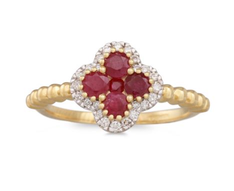 A RUBY AND DIAMOND CLUSTER RING, the central ruby to diamond surround, of shaped form, mounted in yellow gold, size L