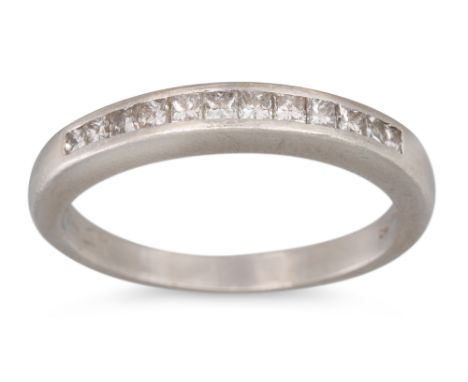 A DIAMOND HALF ETERNITY RING, channel set with princess cut diamonds, mounted in platinum, size M