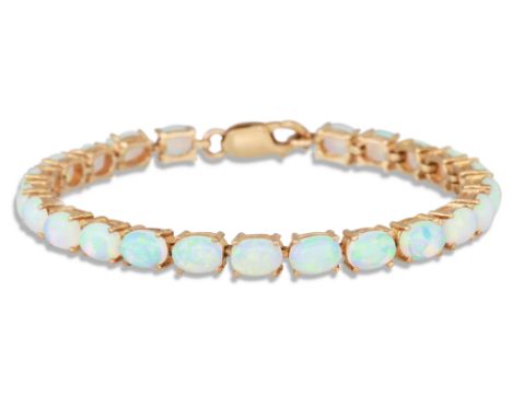 AN OPAL LINE BRACELET, the oval opals mounted in 9ct yellow gold