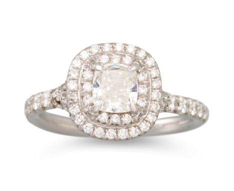 A TIFFANY &amp; CO DIAMOND CLUSTER RING, the cushion cut diamond to brilliant cut diamond surround, mounted in platinum, stam