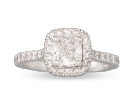 A DIAMOND SOLITAIRE RING, the brilliant cut diamond to round brilliant cut surround and shoulders, mounted in platinum. Toget