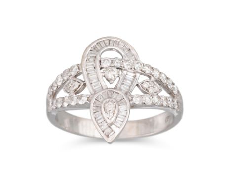 A DIAMOND CLUSTER RING, set with baguette and brilliant cut diamonds, stamped .750. Estimated: weight of diamonds: 1.10 ct. s