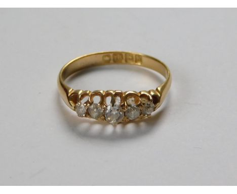 EDWARDIAN RING. An 18ct. gold five stone diamond ring, each old cut stone of cushion shape. Birmingham 1907. Size O/P.  Pleas