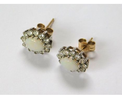 OPAL EARRINGS. A pair of 9ct. gold mounted opal & clear stone, cluster stud earrings.  Please note that all items in this auc