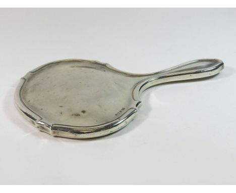 HAND MIRROR. A silver mounted hand mirror with bevelled glass. (Some chipping to mirror).  Please note that all items in this