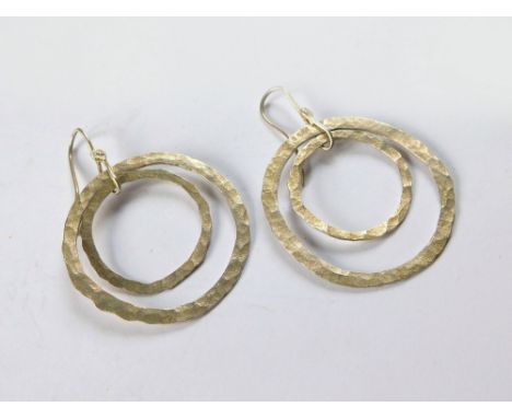 SILVER EARRINGS. A pair of hand made, beaten silver earrings. Diameter of largest circle 4cm. Length 5.5cm.  Please note that