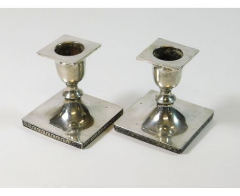 SILVER CANDLESTICKS. A pair of Walker & Hall, low silver candlesticks with Greek key decoration. Sheffield 1921. Height 7.5cm