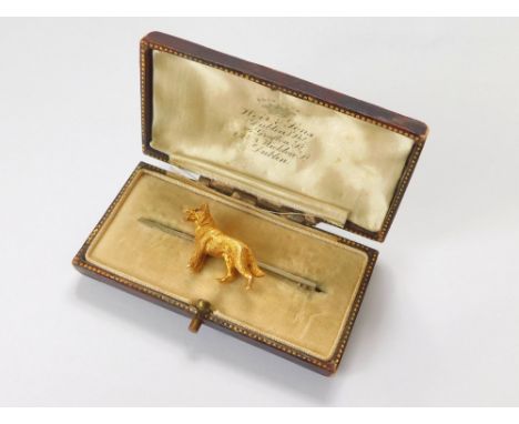 DOG PIN. A 9ct. yellow & white gold Alsatian dog bar brooch, set with a ruby eye. Original jewellery box for Weir & Sons Ltd.