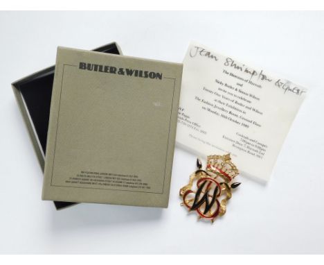 BUTLER & WILSON/JEAN SHRIMPTON. A Butler & Wilson gilt metal, enamel & paste brooch produced to celebrate 21 years of Butler 