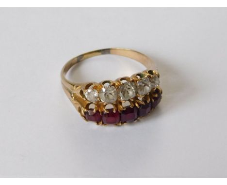 DIAMOND RING. An unusual dress ring, the shank split & set a row of five table cut garnets & five old cut, cushion shaped dia