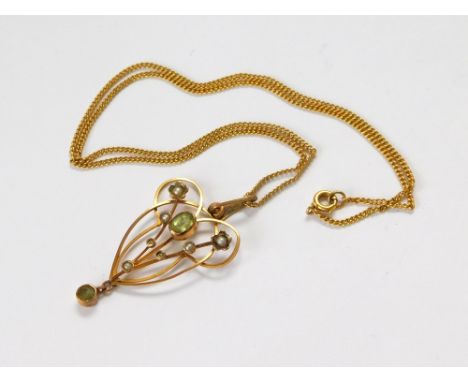 GOLD PENDANT. A 9ct. gold Edwardian peridot & seed pearl pendant, on 9ct. gold chain.  Please note that all items in this auc