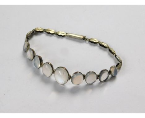 MOONSTONE BRACELET. A vintage moonstone bracelet set a row of graduated blue moonstones. Length 18cm.  Please note that all i