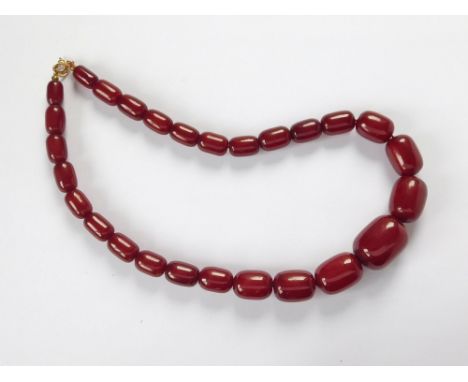 BAKELITE BEADS. A string of tubular dark red bakelite beads. Length 50cm. Largest bead, 2.5 x 2cm.  Please note that all item